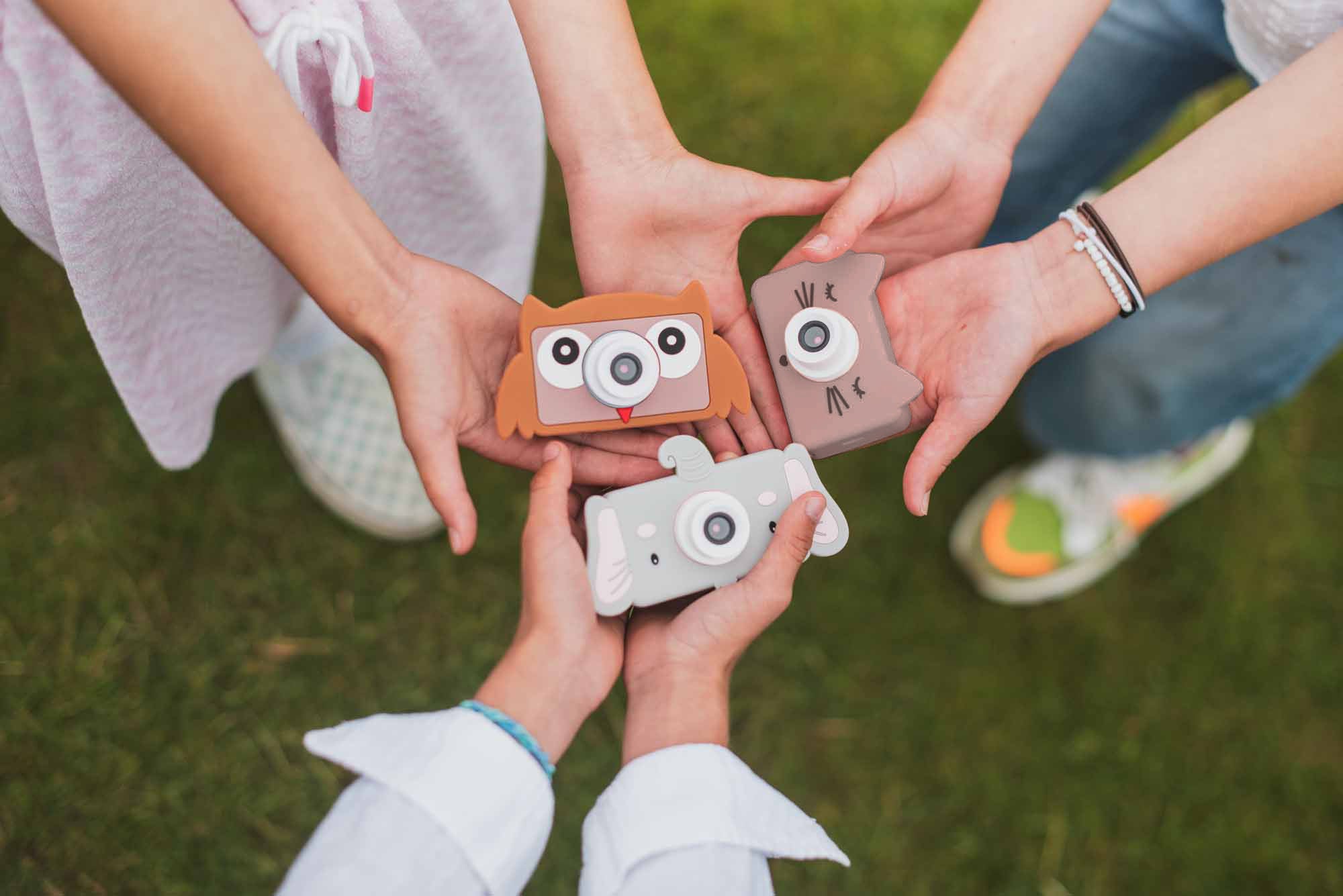 mix of owl, cat and elephant kids digital cameras, kids holding the cameras in their hands