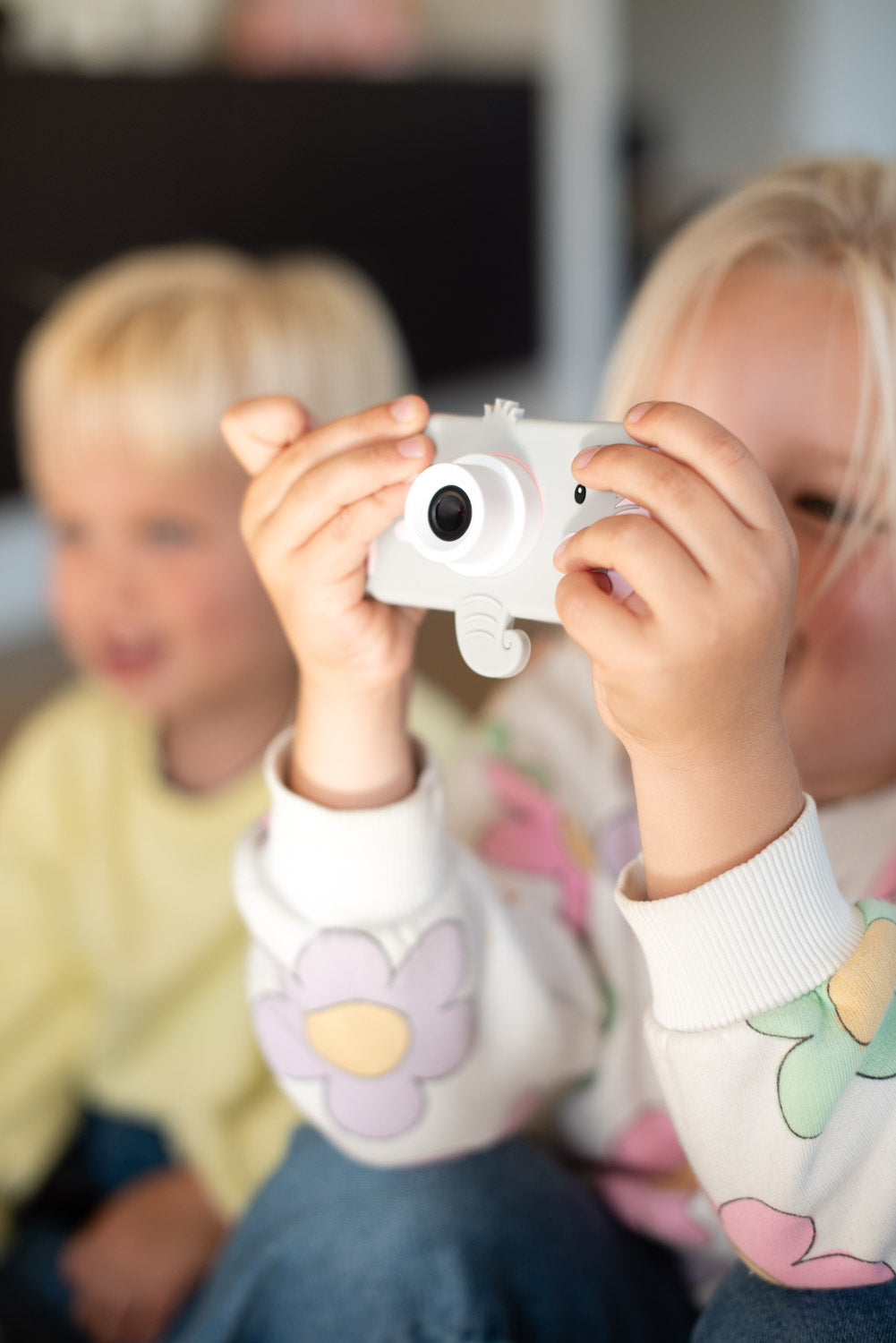 elephant digital kids camera, children are sitting next to each other playing with the camera