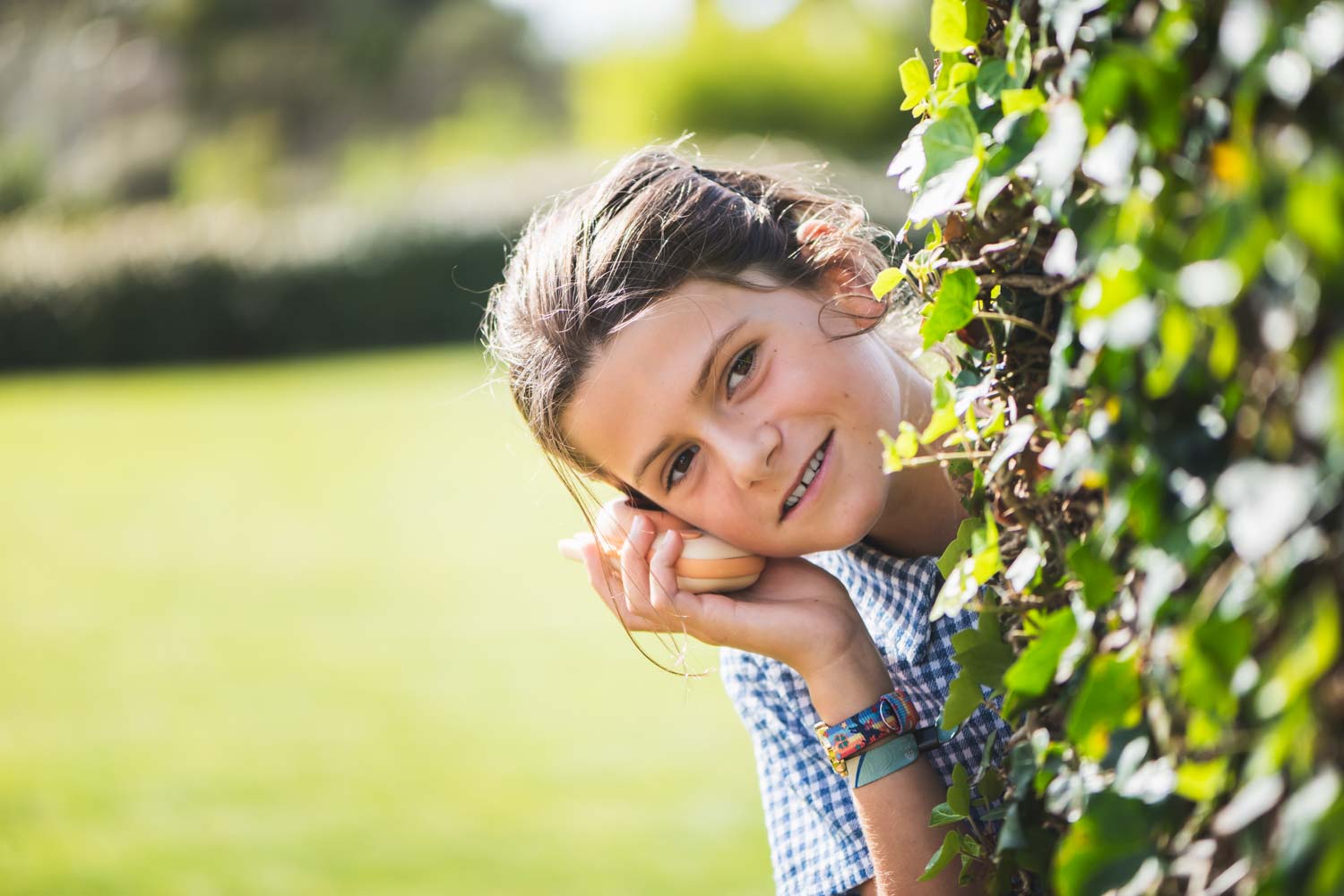 zoo walkie talkie fox, child is standing behind a bush in the garden, listening at the walkie talkie