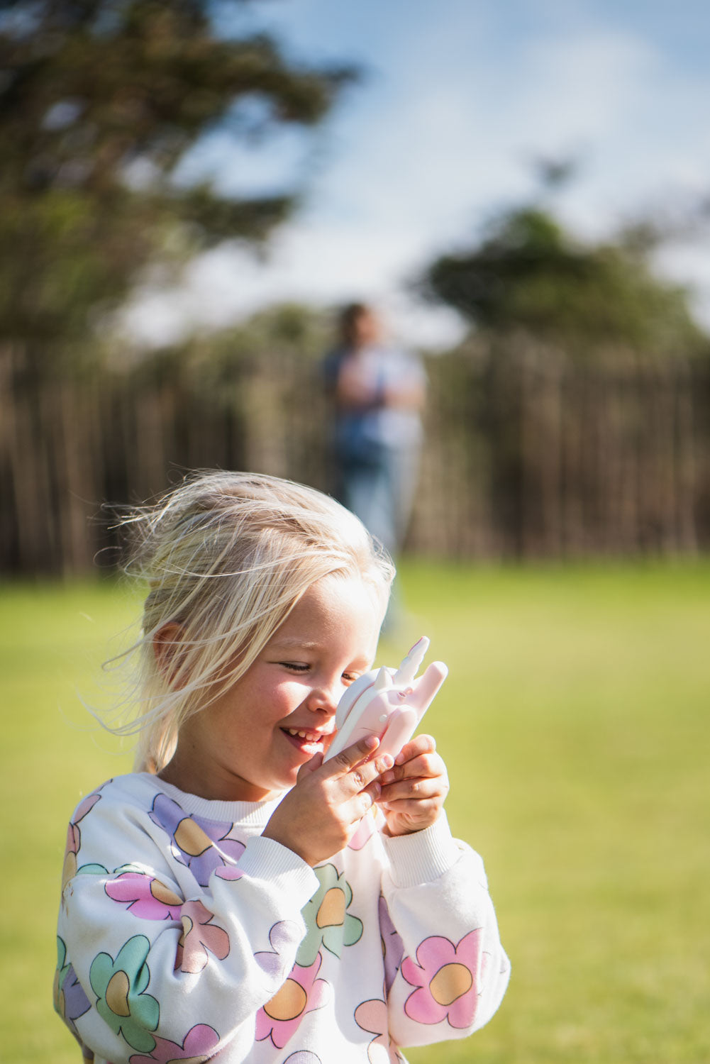 zoo walkie talkie unicorn, child is speaking in the walkie talkie while standing outside