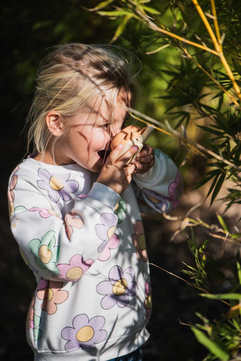 zoo walkie talkie fox, child is standing behind a bush while talking into the walkie talkie