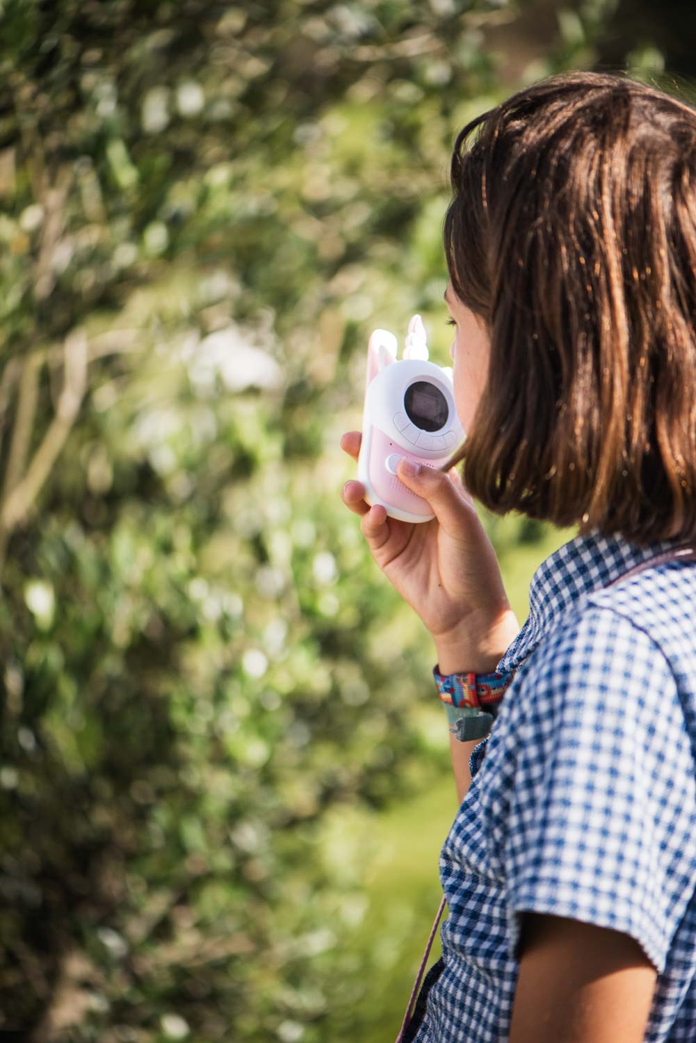 zoo walkie talkie unicorn, child is speaking into the walkie talkie, standing outside