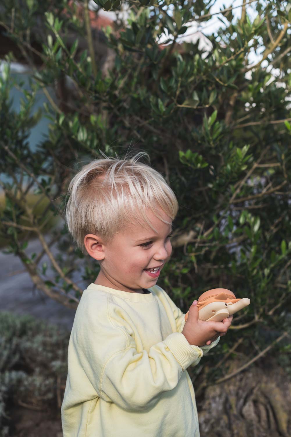 zoo walkie talkie fox, child is standing in the garden while laughing and having fun with the walkie talkie