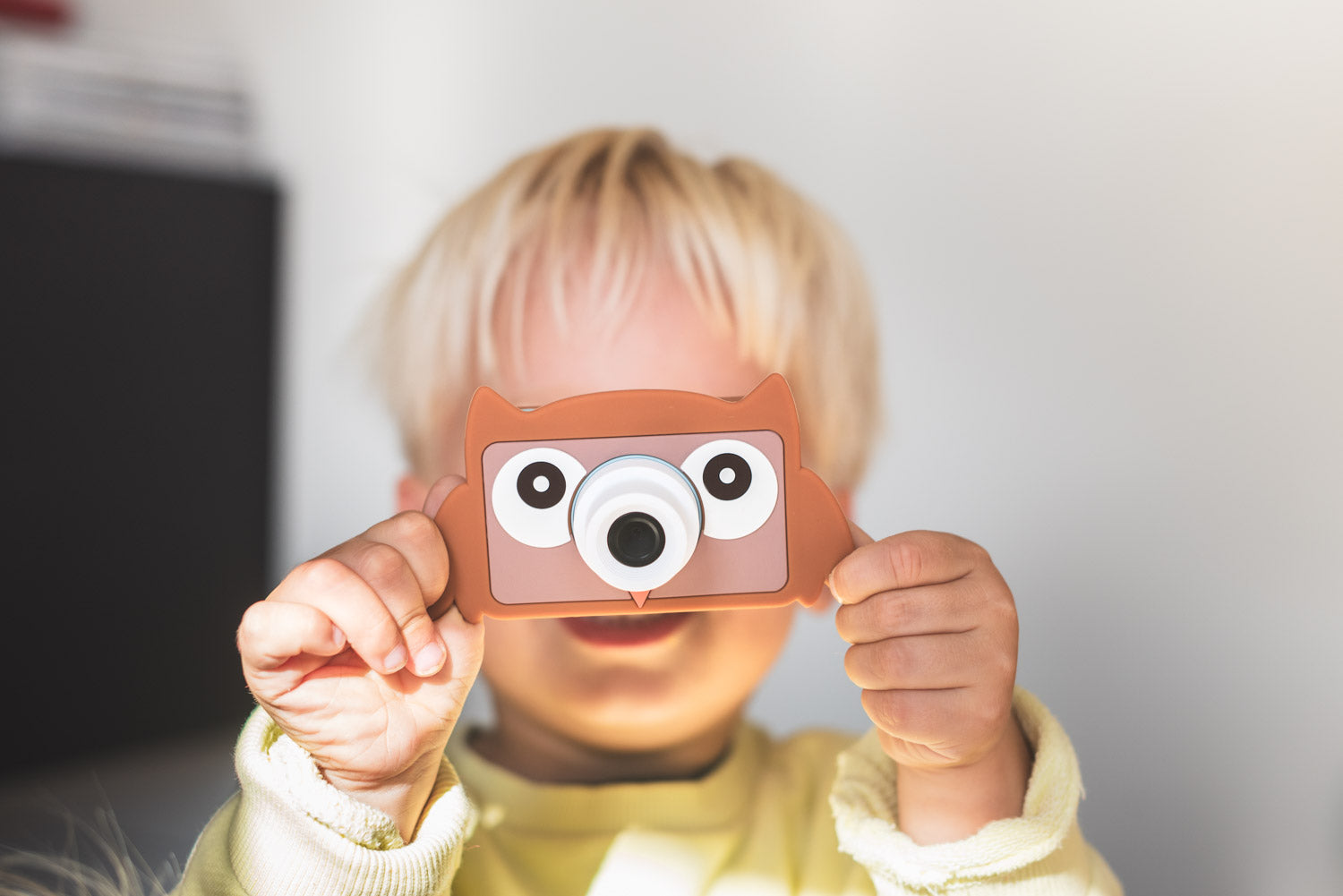 owl digital kids camera, child is holding the camera in its hands before its face