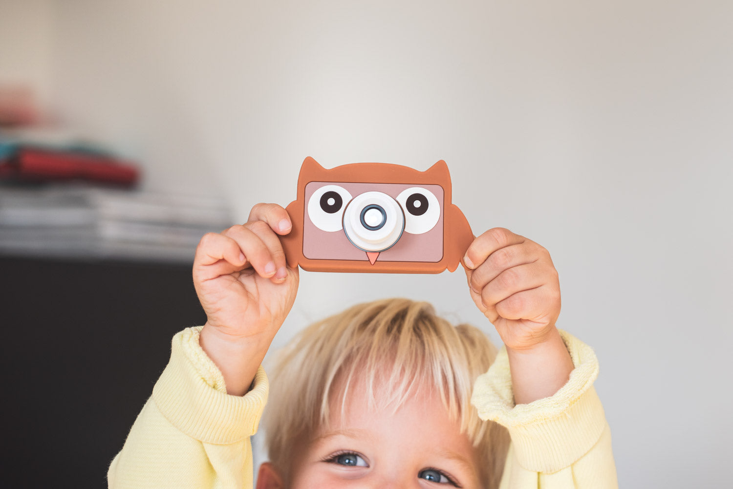 owl digital kids camera, child is laughing while showing the camera up in the air