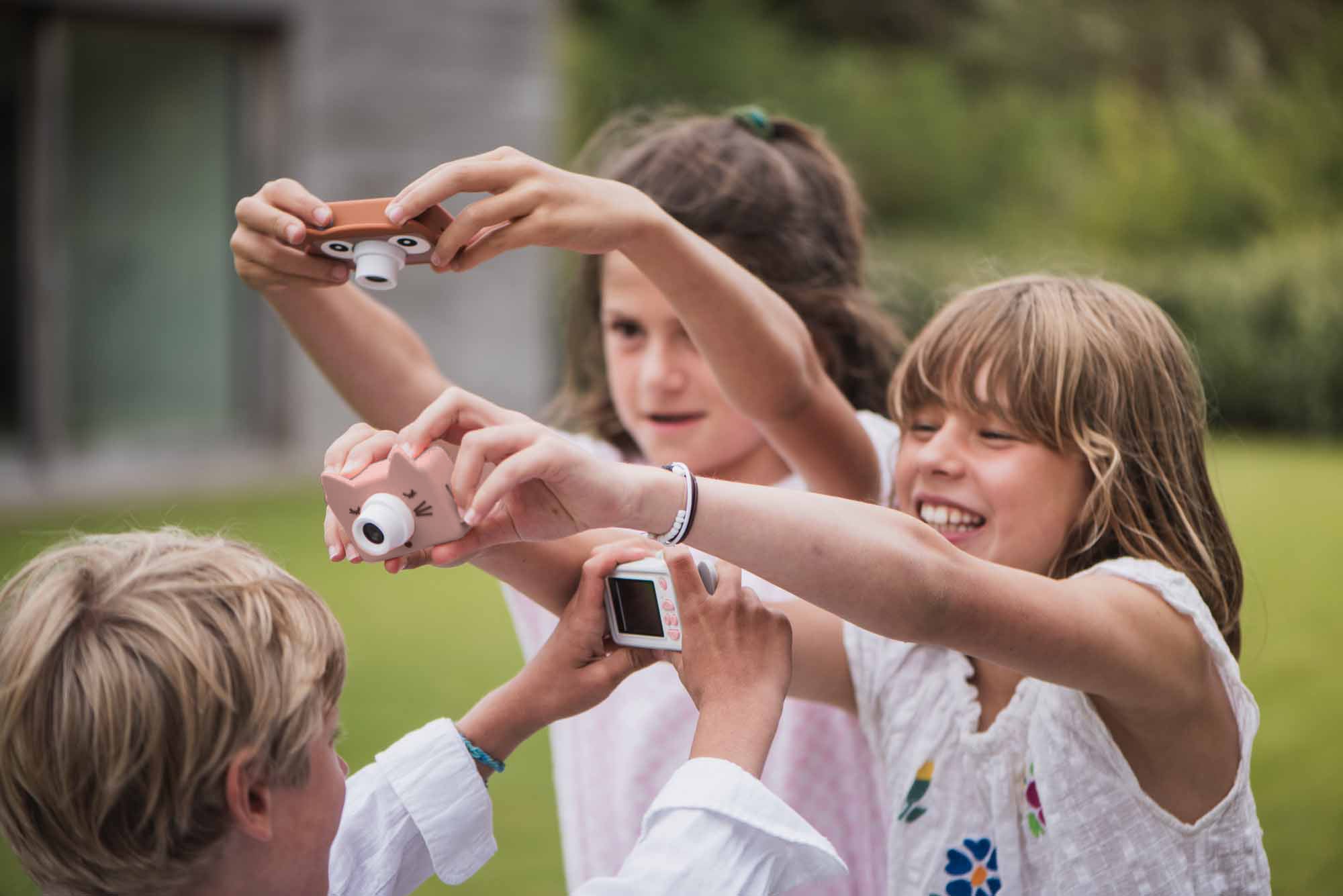 mix of cat, owl and elephant kids digital camera, kids are playing with the cameras in the garden