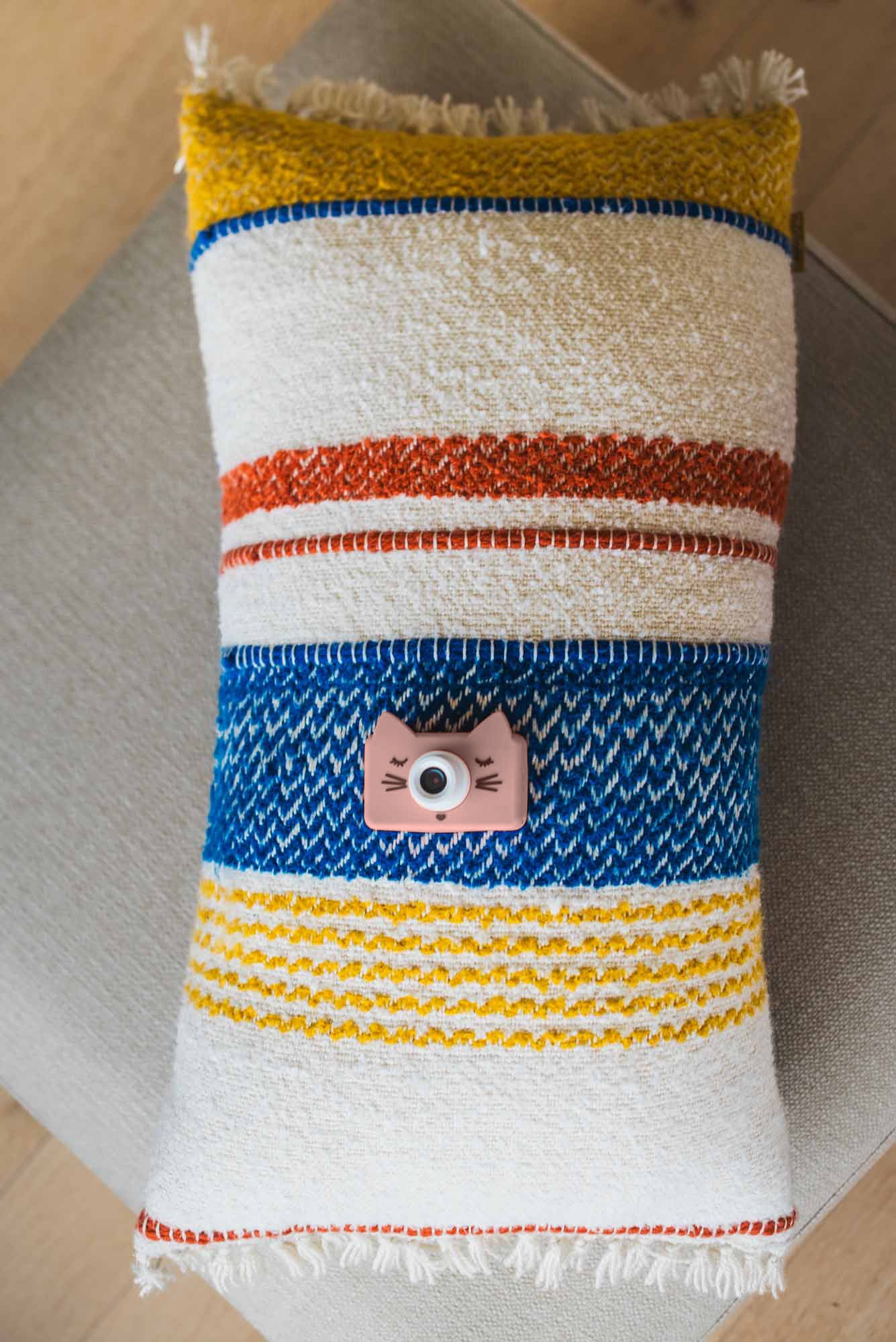 cat kids digital camera, lying on a pillow