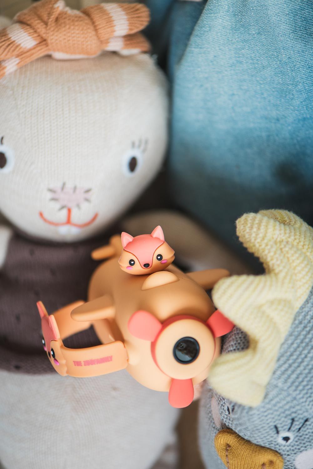 zoo video fox digital kids camera, lying in sofa between dolls