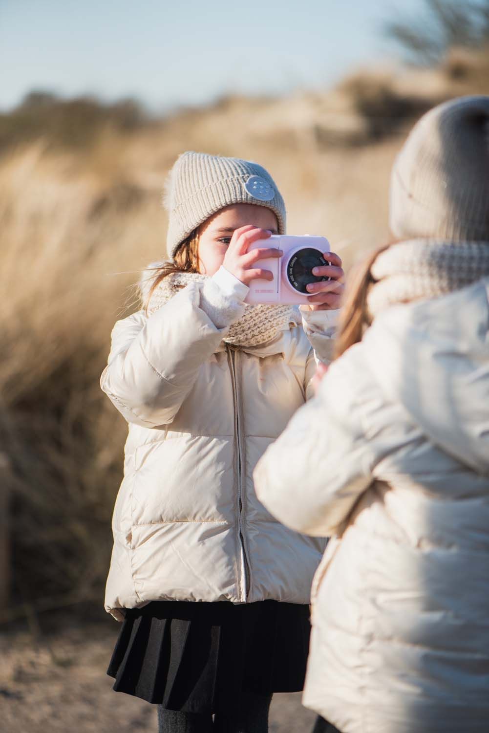 zoo print unicorn digital kids camera, child is taking a picture of its friend at the beach