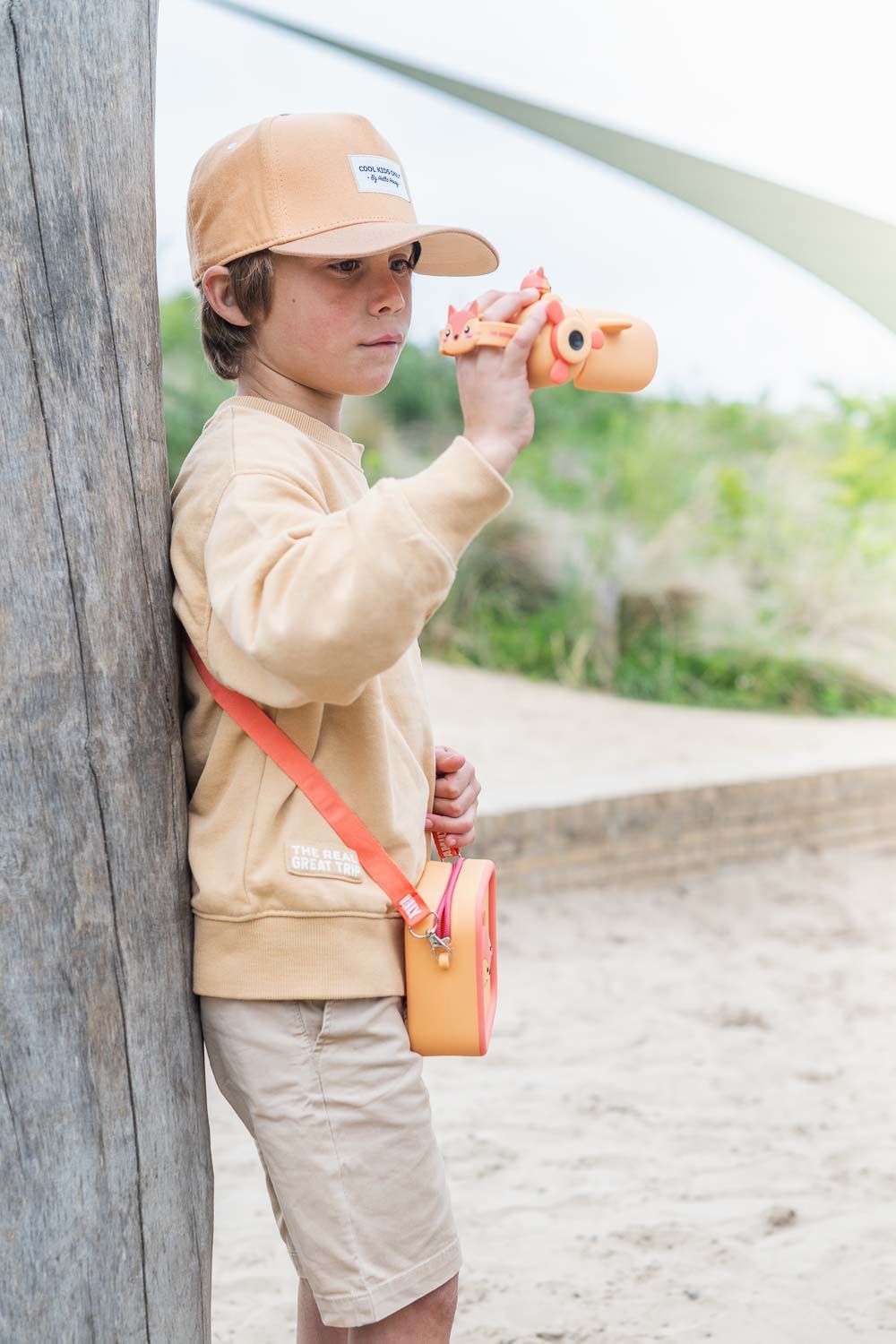 zoo video fox digital kids camera, child is wearing a silicon fox bag while making a video with its camera