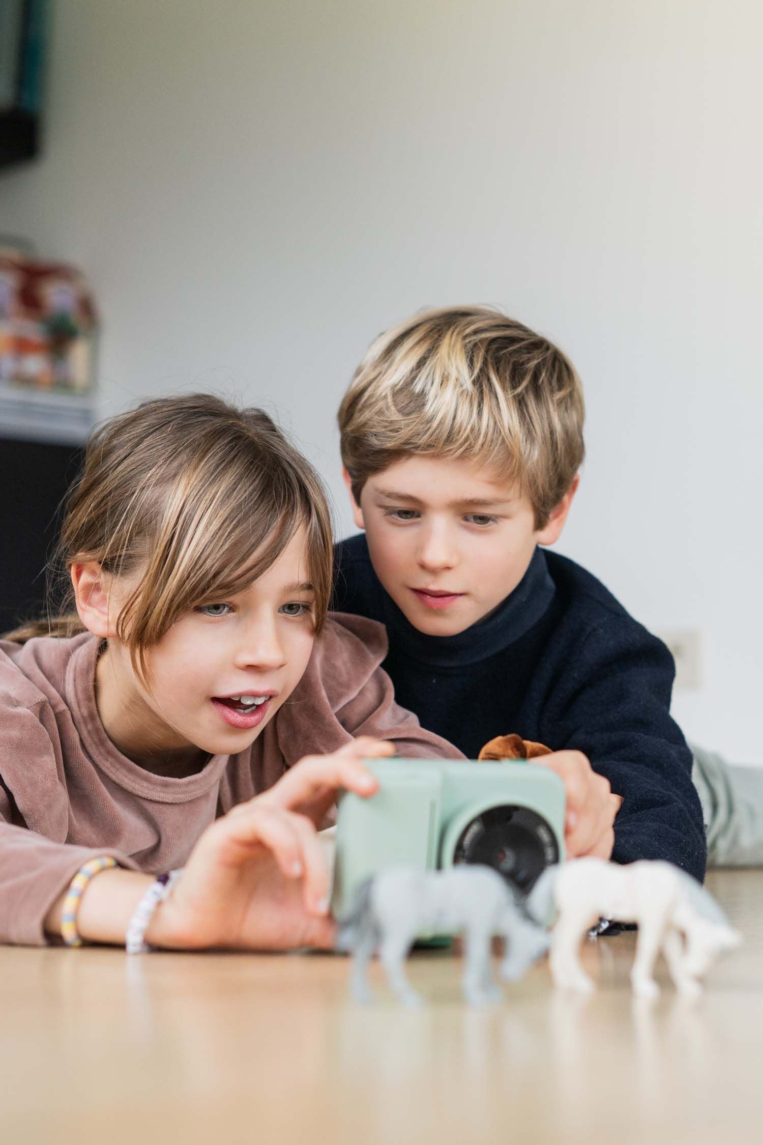 zoo print dino green digital kids camera, children are taking a picture of animal toys