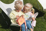 odalsilicon bag fox and unicorn, kids sitting in a chair in the garden