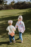 odalsilicon bag unicorn and fox, children are having the bags over its shoulder while walking in the garde, hand in hand