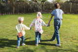 odalsilicon bag fox and unicorn, children are carrying the bag over its shoulder while walking in the garden, hand in hand