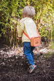 odalsilicon bag fox, child is carrying the bag over its shoulder while walking between the bushes