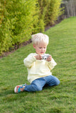 odalelephant digital kids camera, child is sitting outside looking at the camera in its hands