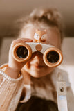 odalA girl is looking through her binoculars.