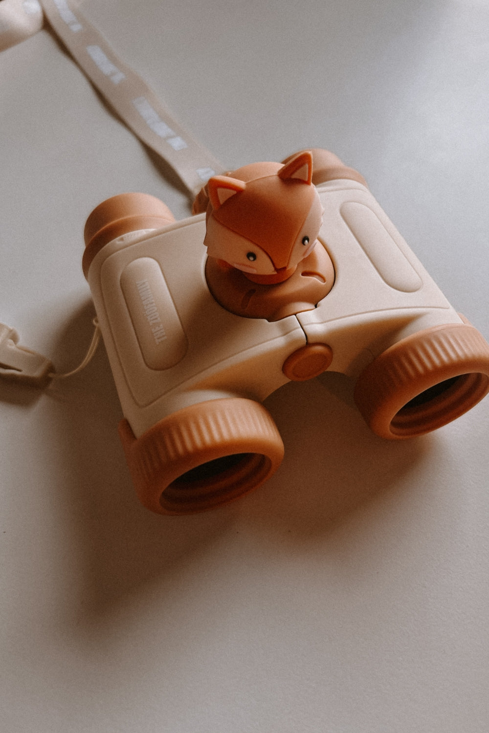 The binoculars are lying on the surface.