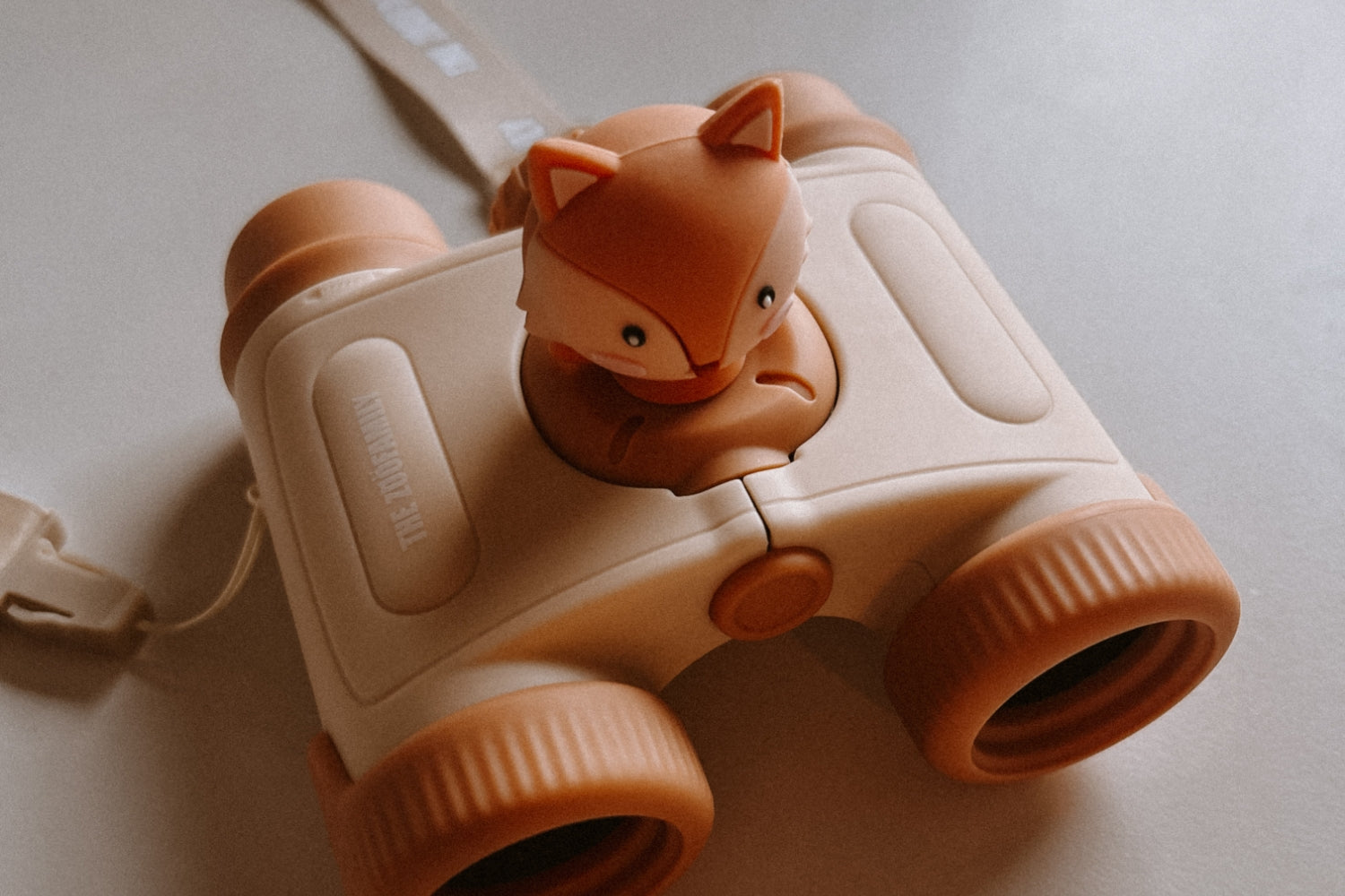 The binoculars are lying on the surface.