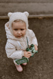 odalA girl is looking into the distance, holding binoculars.