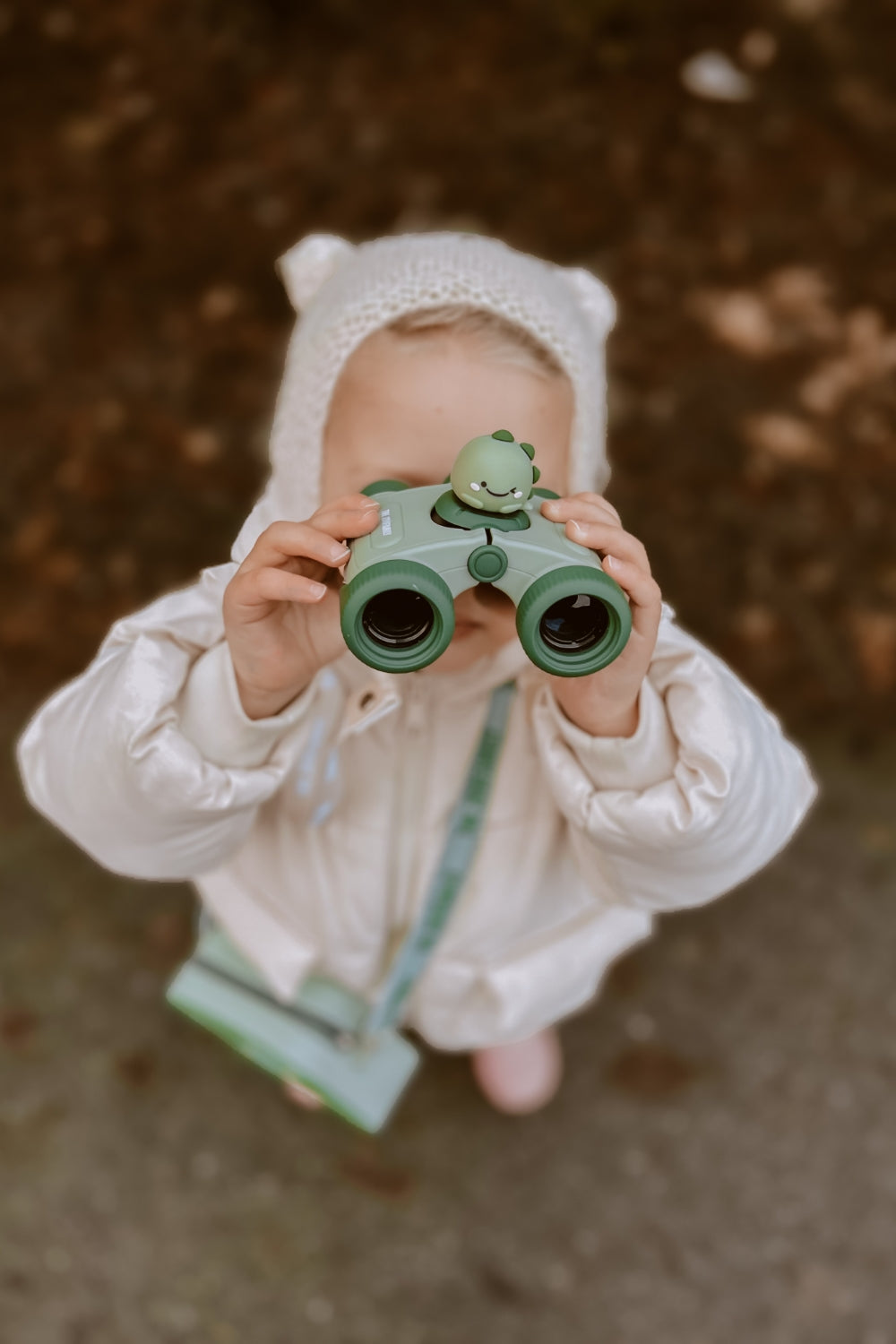 A girl is looking through binoculars.