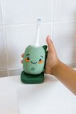 odalA hand holding a dino toothbrush 