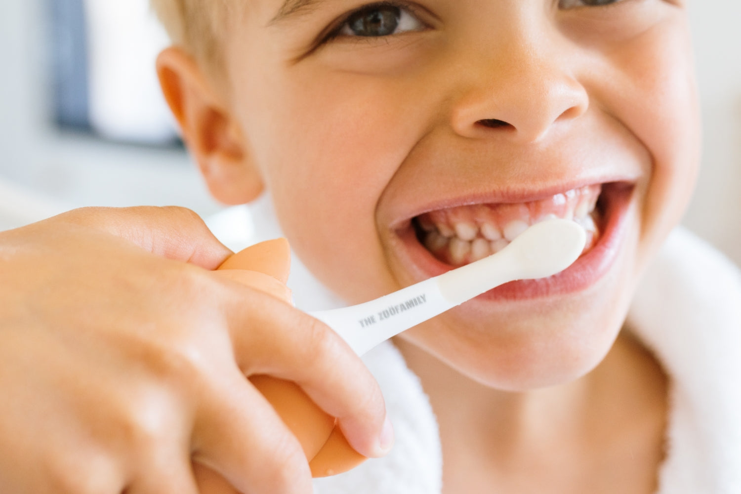 A child brushing their teeth with the Fox toothbrush.