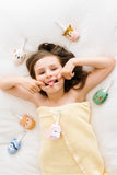 odala young girl with  several toothbrushes with animal designs around her 