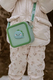 odaldino green silicon bag, child is carrying the bag above its jacket