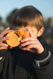 odalurban zoo bear digital kids camera, child is holding the camera with lenscover in its hands, prenteding to make a picture