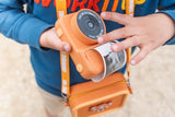 odalzoo print bear digital kids camera, child is printing a taken picture while wearing the silicon bear bag