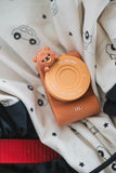 odalurban zoo bear digital kids camera, lenscover, camera is laying on a storage bag of Play&Go