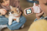odalzoo video unicorn digital kids camera, child is filming a friend who is holding a dog