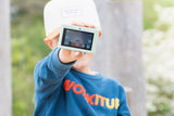 odalurban zoo dino green digital kids camera, child is showing the back side of the camera with the screen