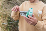 odalzoo print dino green digital kids camera, child is waiting for a printed picture