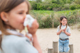 odalwalkie talkie rabbit set, children are sitting at a tree trunk while playing with the walkie talkies
