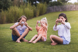odalpenguin, unicorn and fox kids cameras, children sitting in garden while taking pictures