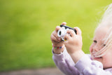 odalpenguin kids camera, child standing outside while taking a picture