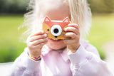 odalfox kids camera, child holding camera with both hands while making a picture