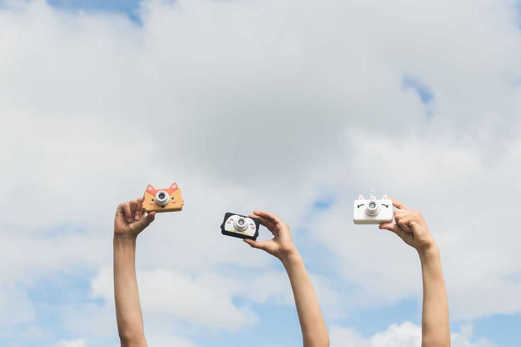 fox, penguin and unicorn kids cameras, children holding the cameras in the air