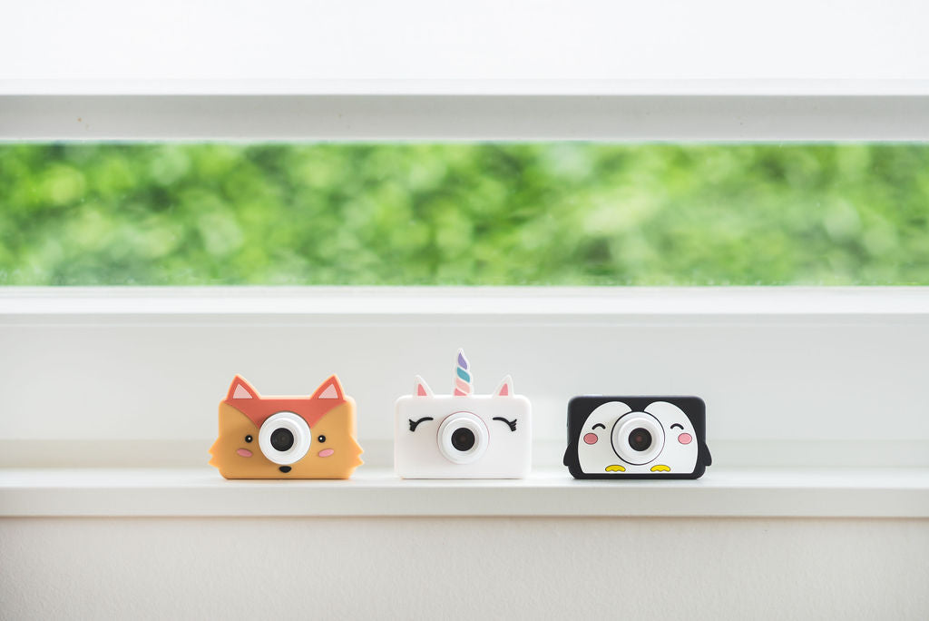 penguin, unicorn and fox kids cameras, standing on window sill